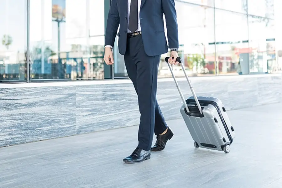 an businessman carrying his prestigious aluminum luggage with pride | luggagelovers.com