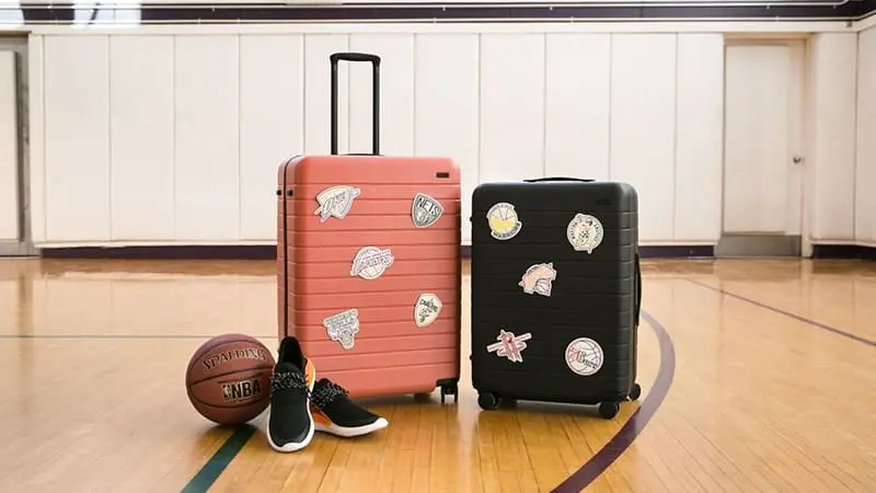 Two different colored away luggage with stickrs pasted on them. Away Black and Brown Color Luggage