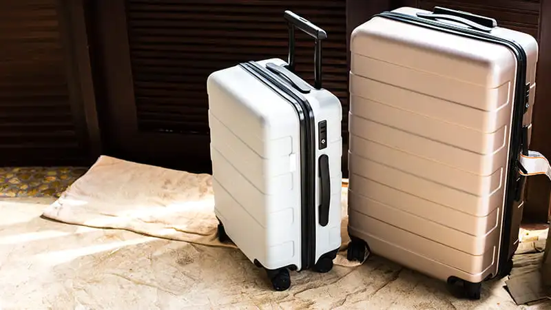 Dusty White Suitcases standing at Hotel Room 