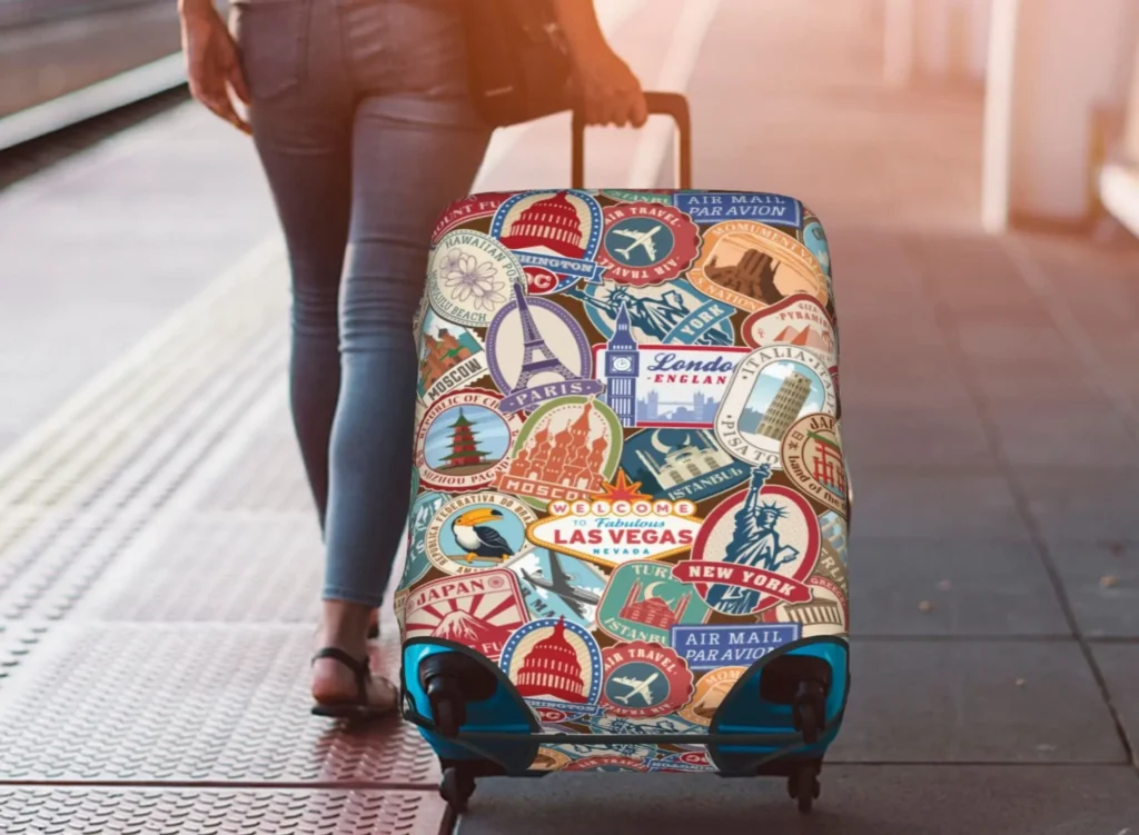 A women carrying her luggage covered with a polyester luggage cover. luggagelovers