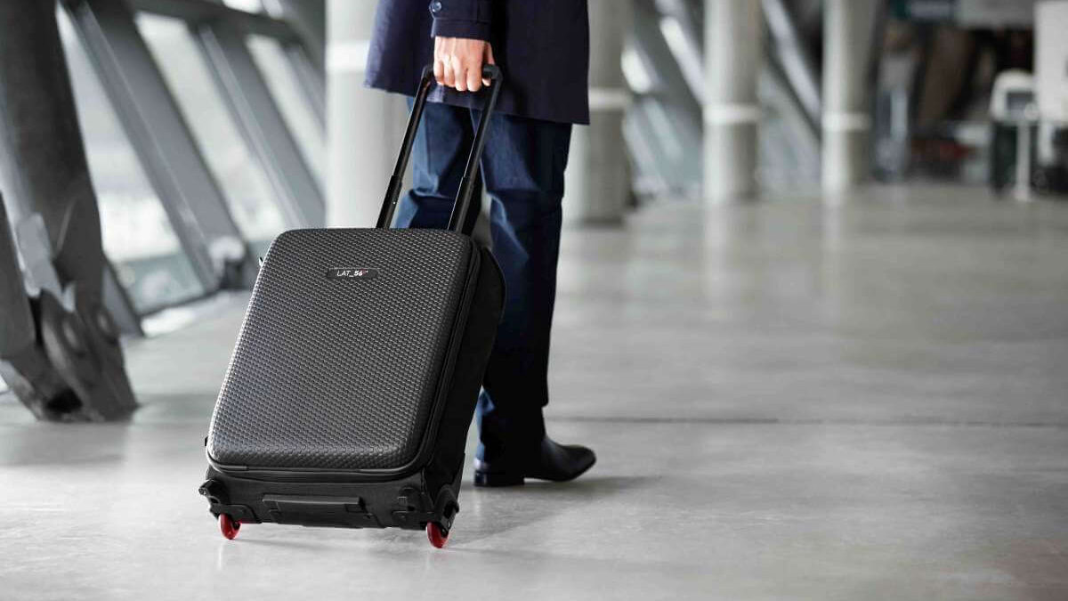 A man walking with roller or 2 wheel luggage