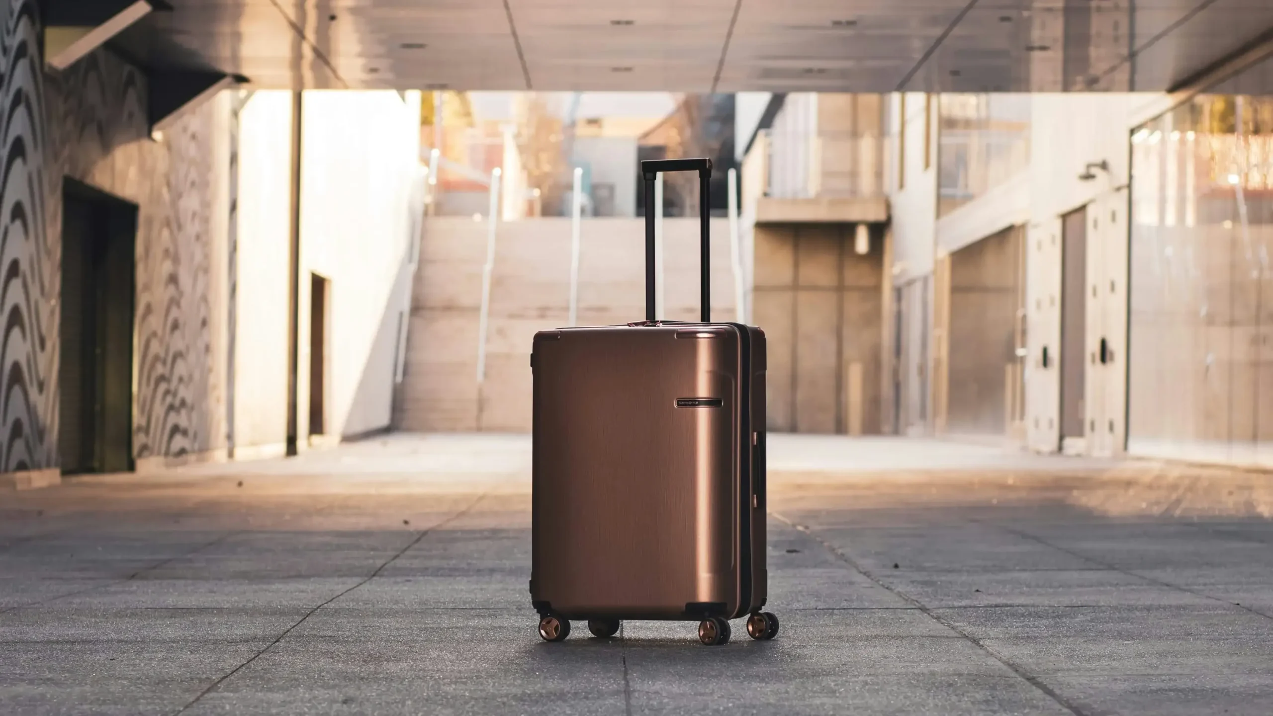 a spinner or 4 wheels luggage standing on floor